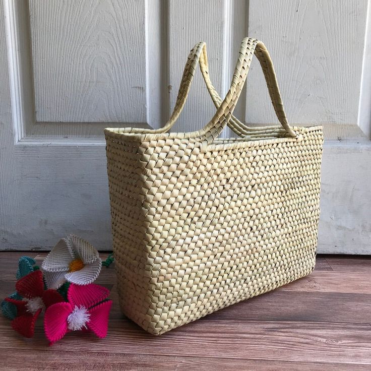 "This beautiful Palm Leaf Basket was handwoven. Ideal for shopping, picnic or the beach! MADE IN MEXICO By: Mexican Artisans For: Women Color: Basic Dimensions: 13.5 x 10.25 x 3.5 Details: - Style: Tote Bag - Material: palm leaf - Handles: 5\" Drop - Flat bottom Contact us for more details READ BEFORE PURCHASE: The picture is an ACCURATE REPRESENTATION. Colors in the pictures may vary a little by effects of light. Each product is handmade from Mexico causing differentiation and minor imperfections in each piece making them that much more unique. We strive to have consistency within our business but please be aware not all pieces are 100% alike. WE RECOMMEND READING OUR RETURN POLICY & SHIPPING POLICY BEFORE PURCHASE" Casual Rectangular Braided Crochet Bag, Rectangular Braided Bag In Natural Fiber, Rectangular Braided Bag From Natural Fiber, Rectangular Braided Straw Bag, Rectangular Braided Natural Fiber Bag, Braided Natural Fiber Rectangular Bag, Summer Woven Rectangular Shoulder Bag, Casual Woven Palm Leaf Beach Bag, Casual Woven Rectangular Straw Bag