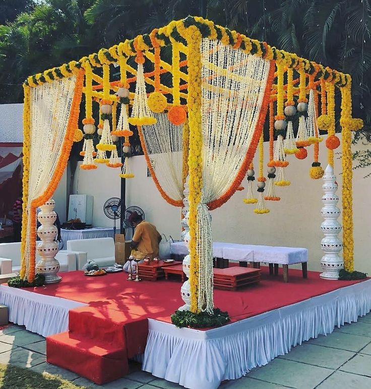 an outdoor wedding setup with orange and white decorations