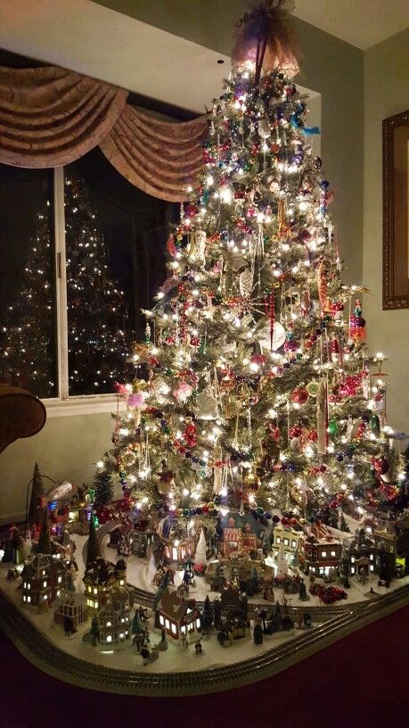 a christmas tree that is sitting in front of a window