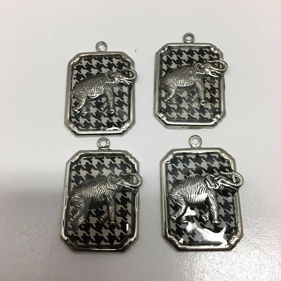 four pendants with an elephant on them