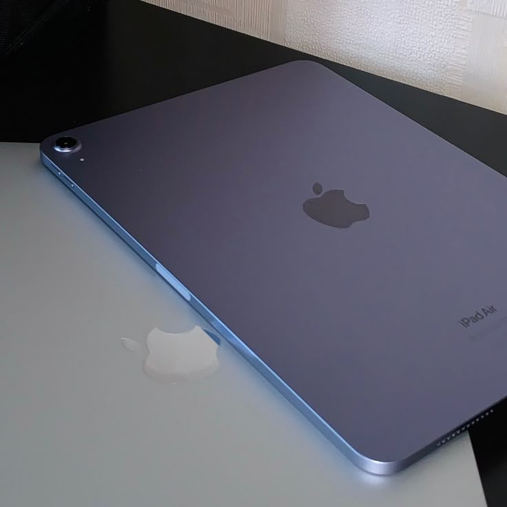 an apple laptop computer sitting on top of a table