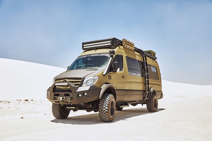 an off - road vehicle is parked in the desert