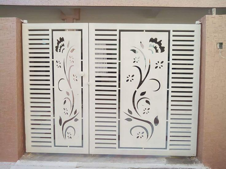 two white doors with decorative designs on them