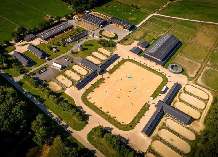 an aerial view of a large building in the middle of a field