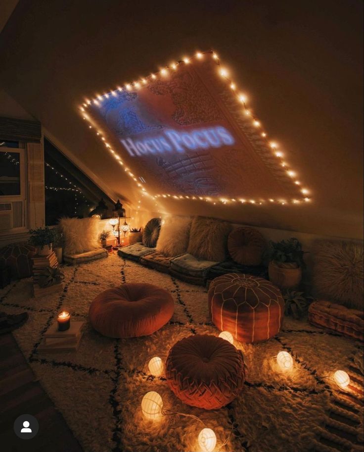 a room that has some lights on the ceiling and candles in front of it,