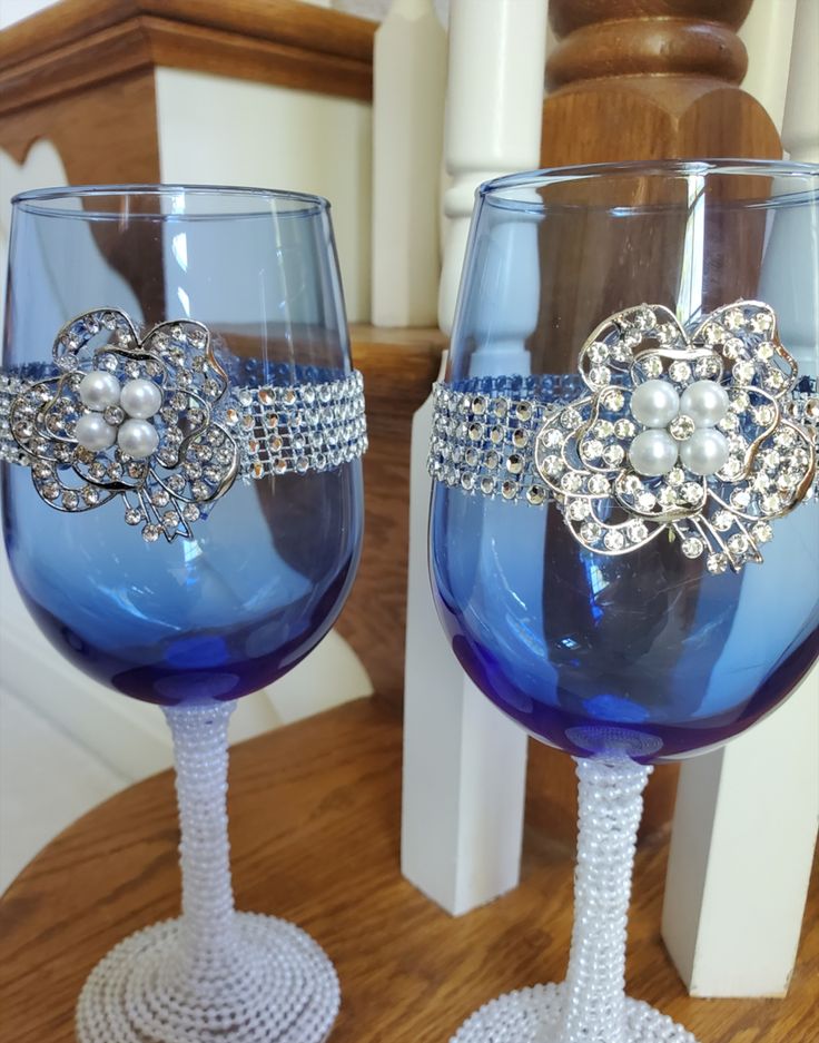 two wine glasses decorated with pearls and bows