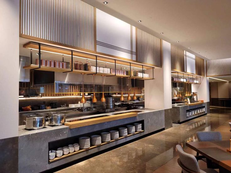 an empty restaurant with tables, chairs and shelves full of food on the counter top