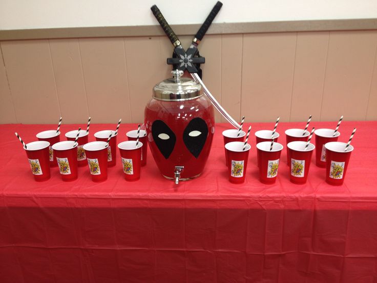 a red table topped with cups filled with drinks