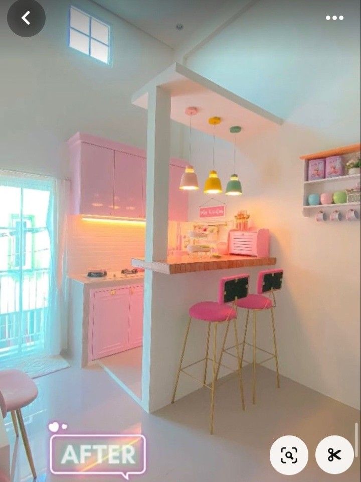 a pink kitchen with two stools in it