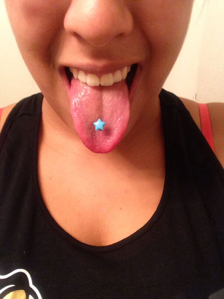 a woman sticking her tongue out to show it's tongue