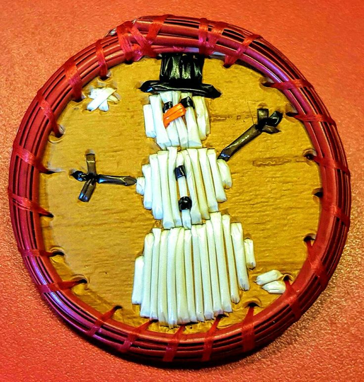 a snowman made out of toothpicks in a basket