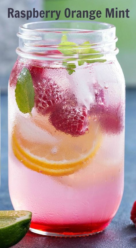 a mason jar filled with raspberry orange mint lemonade