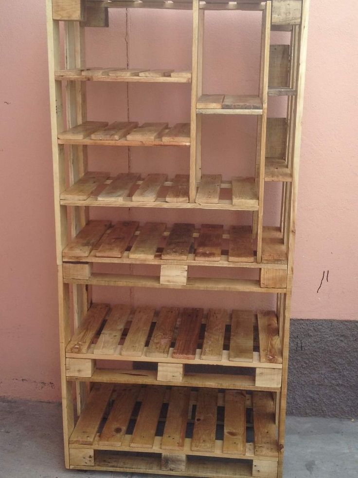 a wooden shelf with several shelves stacked on top of each other