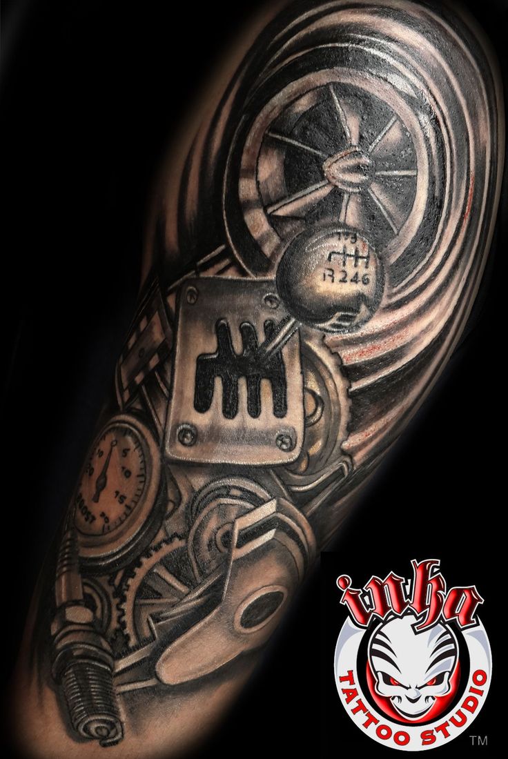 a man's arm with a clock and gears tattoo design on the sleeve,