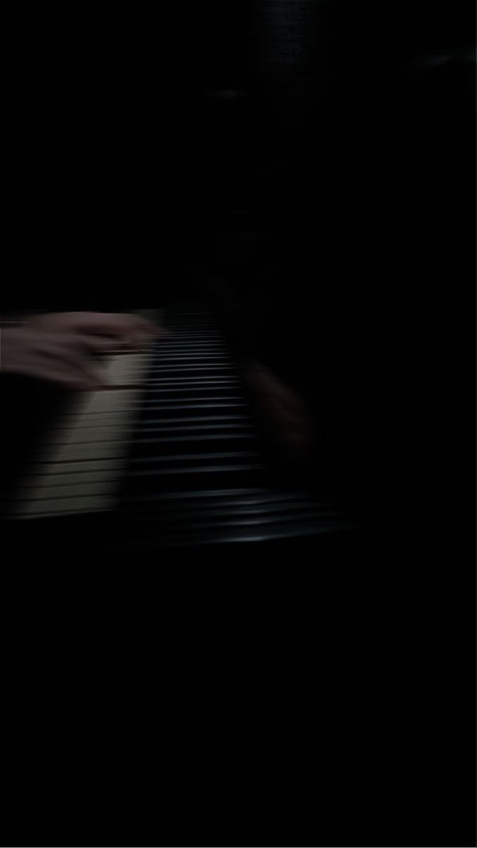 a blurry photo of a piano in the dark