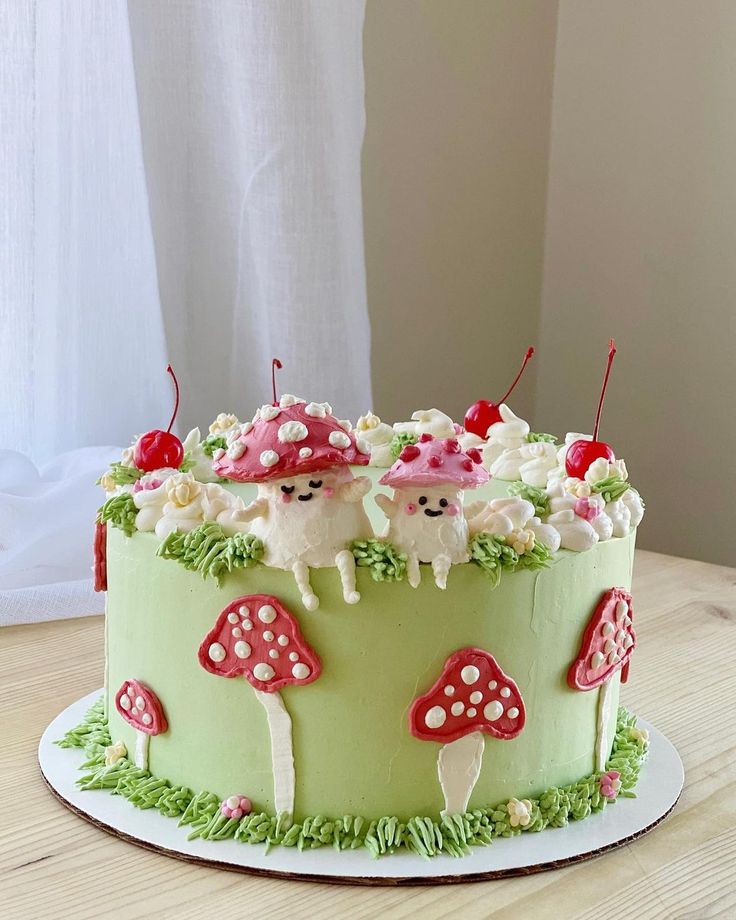 a green cake decorated with mushrooms and cherries