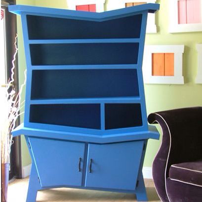 a blue bookcase sitting in the corner of a room