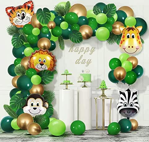 a jungle themed birthday party with balloons, decorations and animal heads on the front wall