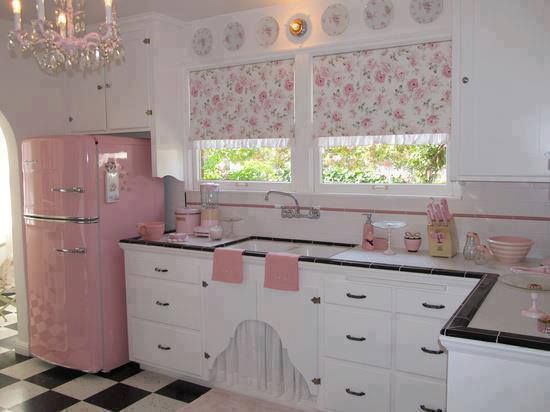 a pink refrigerator freezer sitting inside of a kitchen