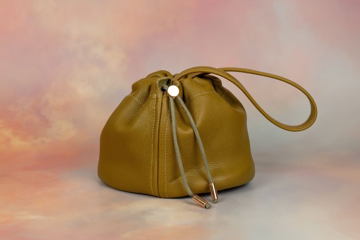 We know you. You want to carry a cute, mini bag, but you also want to fit everything in it. We can relate! Stop leaving your things at home, and start carrying the Duo bag. Not only is it large enough to fit your wallet, phone, sunglasses, and lots of accessories, this leather bucket bag has a drawstring and clasped strap so you can wear it lots of ways. In fact, that’s why we call it Duo! Our two strap settings allow for you to wear it shorter as a chic wristlet or wear it as a slouchy shoulder Modern Pouch Phone Bag For On-the-go, Modern On-the-go Satchel Pouch, Trendy Mobile Phone Bag Pouch For Everyday Use, Modern Phone Bag Pouch For On-the-go, Versatile Everyday Mobile Phone Pouch, Everyday Versatile Mobile Phone Pouch, Trendy Mobile Phone Pouch For Everyday Use, Modern Pouch Phone Bag For Daily Use, Modern Everyday Pouch Phone Bag