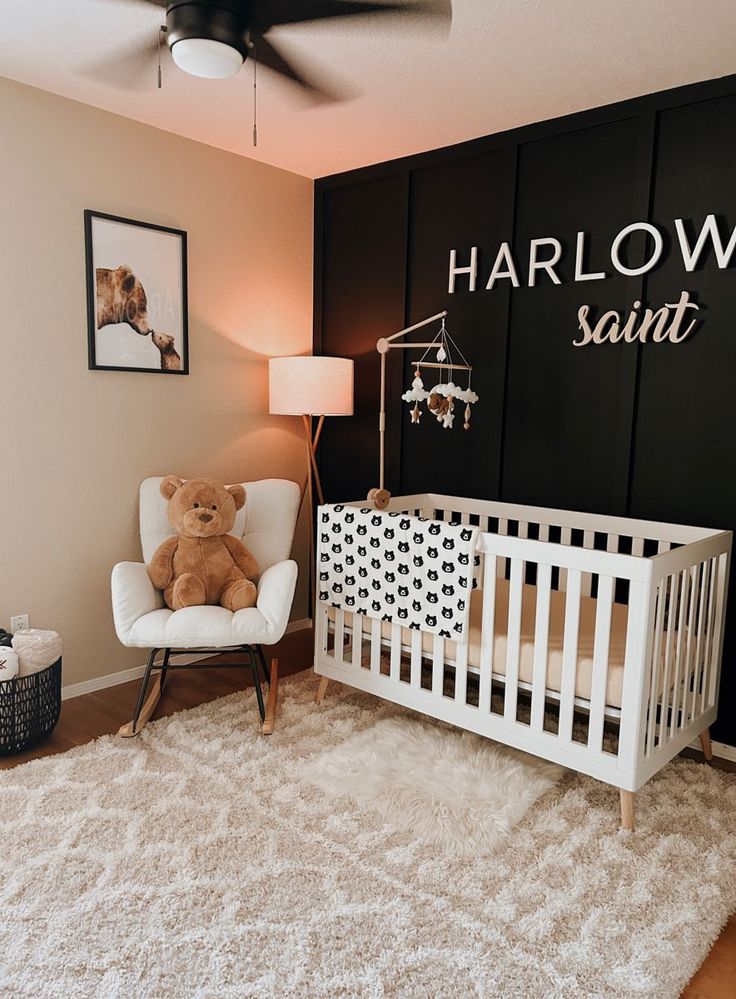 a baby's room with a white crib and a brown teddy bear sitting in it