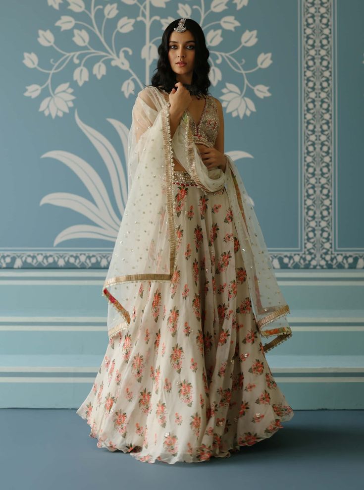 This stunning lehenga set features a beautifully embroidered lehenga, paired with a matching blouse and dupatta. The gold accents and vibrant threadwork create a youthful and joyous vibe, making this ensemble perfect for adding a touch of elegance and cheer to any special occasion. Ivory Lehenga, Indian Arts And Crafts, India Style, Latest Bridal Dresses, Embroidered Lehenga, Indian Textiles, India Fashion, The Gold, Traditional Techniques