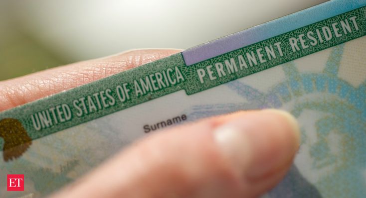 someone is holding a green and white id card in their left hand with the words united states of america permanent resident on it