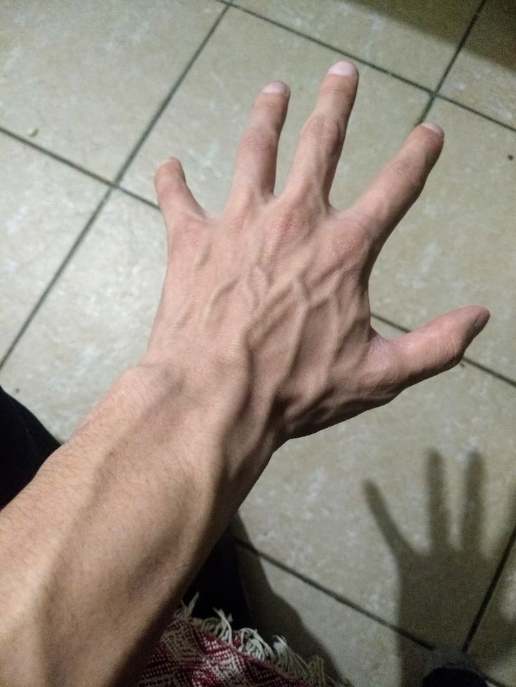 a person's hand reaching for something on the floor