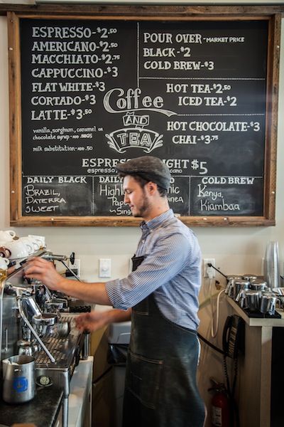 a man is working at a coffee shop