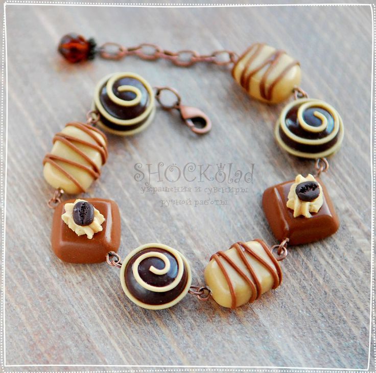 a brown and white bracelet with chocolates on it