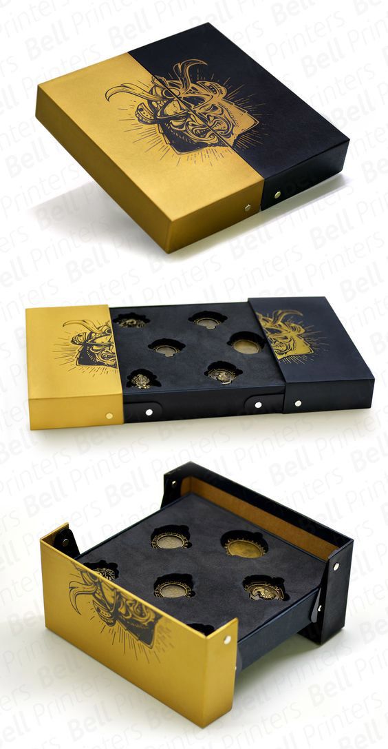 two boxes that have different designs on the inside and outside of them, one is black with gold foil