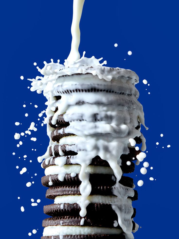 a stack of cookies covered in white icing and drizzled with milk