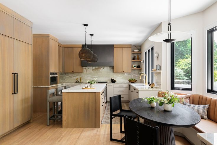 a kitchen with wooden cabinets and an island in front of a window that is open to the outside