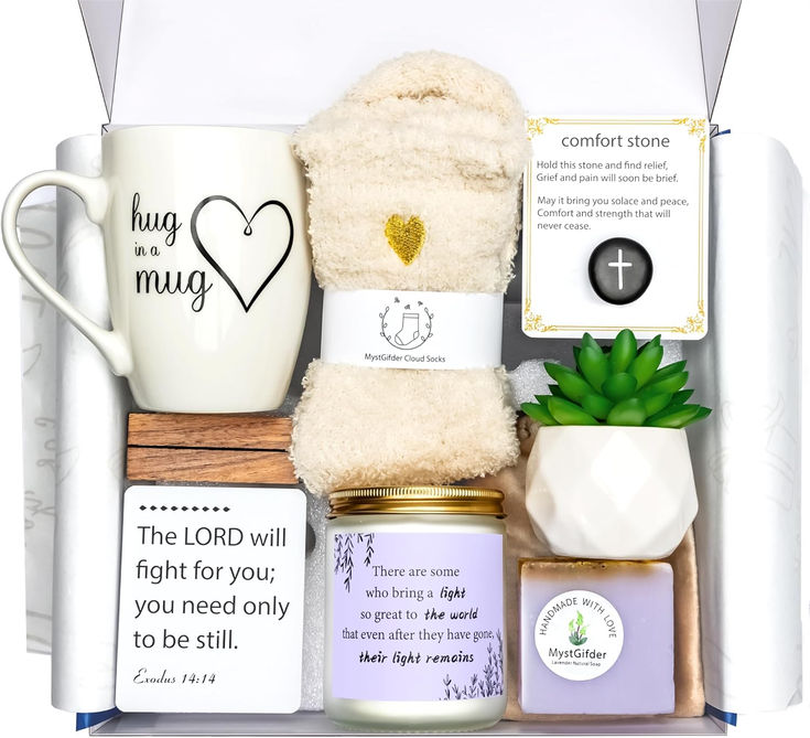 the gift box contains two mugs, a candle and some other items