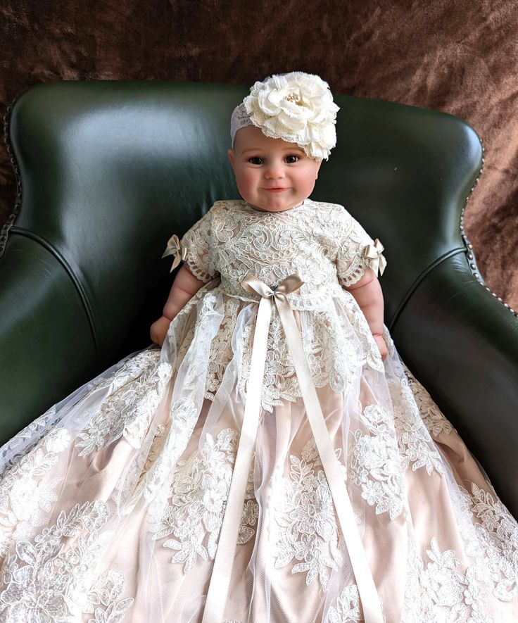 Introducing the Eliana Satin Tulle Christening Gown from Blush Kids, a masterpiece in Champagne hue that redefines heirloom quality for your little angel's significant day. Featuring a majestic dress length of 35 inches with elegant short sleeves, this gown has been meticulously designed to capture the essence of grace and tradition. Crafted with an unwavering attention to detail, it boasts a luxurious blend of four layers, including a soft 100% pure Cotton lining for unparalleled comfort, a lus Princess Style Cream Ball Gown, Cream Lace Princess Dress For Wedding, Princess Style Cream Ball Gown For Wedding, Cream Princess Wedding Gown, Princess Style Cream Wedding Gown, Princess Style First Communion Gown With Lace Bodice, Tulle Baptism Dress With Lace Bodice For Ceremony, Cream Lace Baptism Dress For Pageant, Formal Cream Tulle Gown