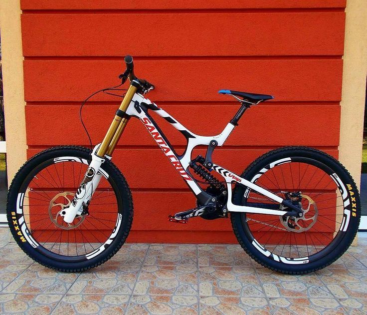 a mountain bike parked in front of a red wall