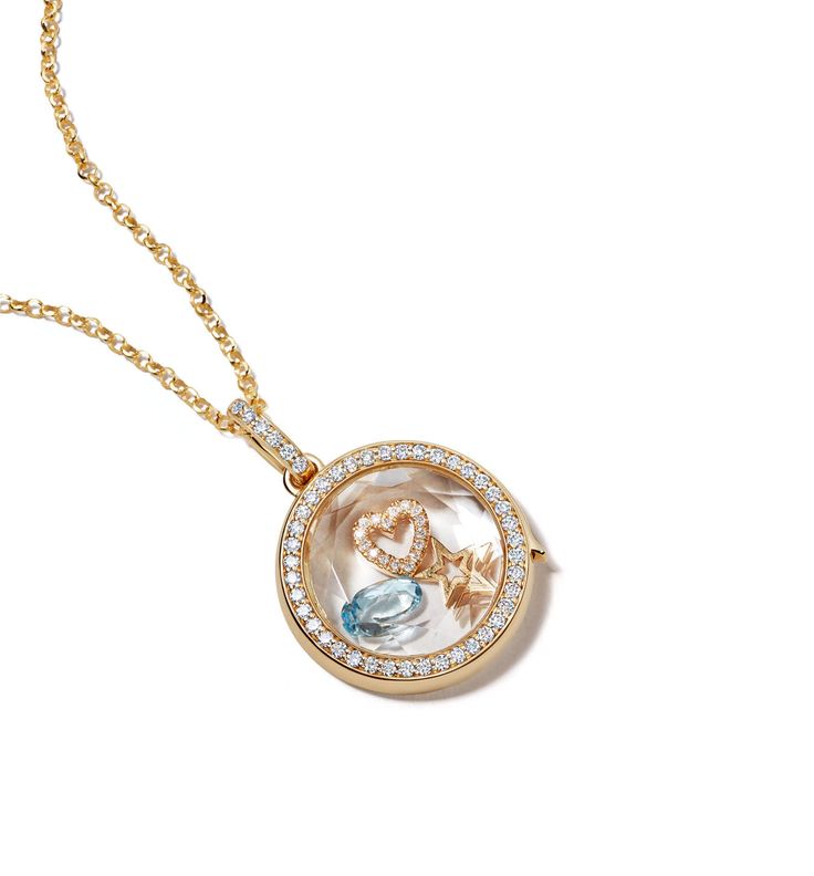 Loquet London specializes in creating joy and memories through handcrafted keepsakes. Using the most ardent care and sustainable practices, each token is hand-finished, so that it is utterly unique and made to last. This locket is inspired by the idea of keepsakes and collecting memories, as a love letter coded in charms. This diamond locket pendant is hand-crafted in 14-karat solid yellow gold and is outlined with a single row of brilliant G VS diamonds and set with a faceted clear sapphire cry Luxury Coin Locket Necklaces, Luxury Gold Locket Necklace For Anniversary, Luxury Keepsake Locket Necklace With Round Pendant, Luxury Locket Jewelry For Anniversary, Luxury Round Pendant Locket Necklace For Keepsake, Luxury Hallmarked Locket Necklace For Wedding, Luxury Round Pendant Locket Jewelry, Traditional Luxury Locket Jewelry, Luxury Locket Necklace With Round Pendant