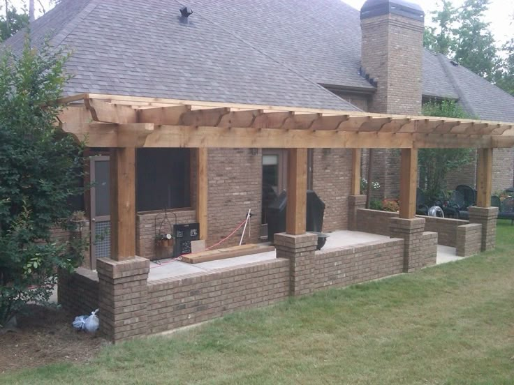 a brick house with an attached porch and covered patio