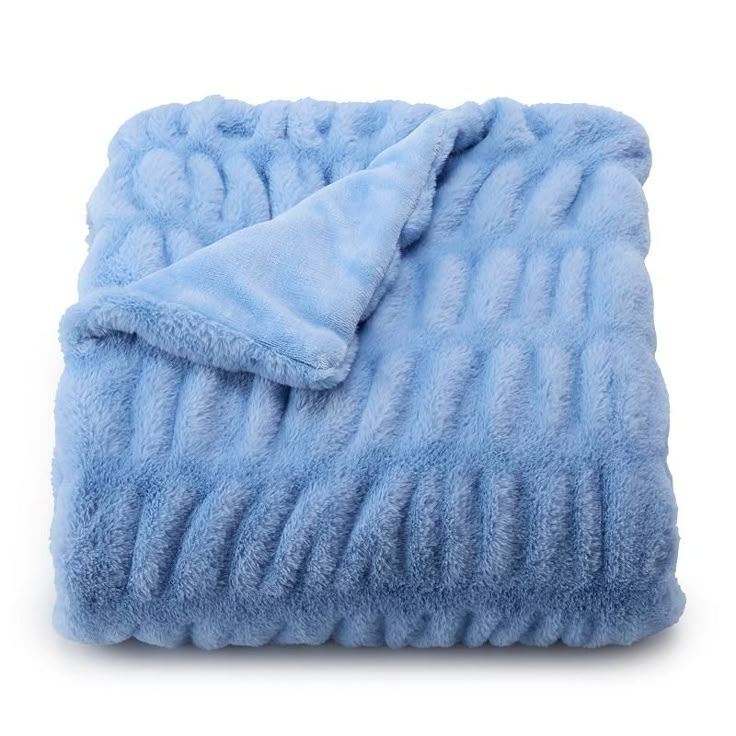 a blue blanket is folded on top of a white surface and it's light blue