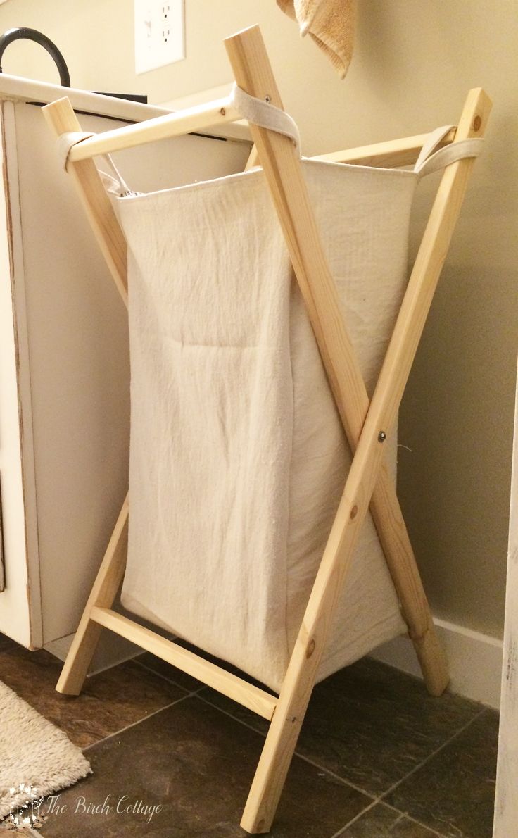 a laundry hamper sitting on top of a wooden rack