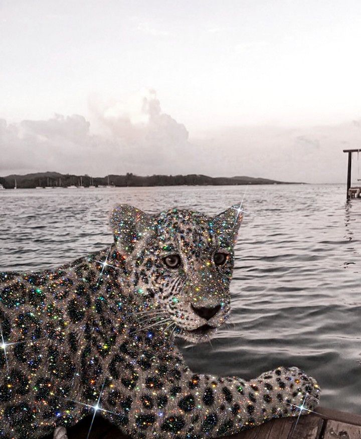 a leopard statue sitting on top of a wooden dock