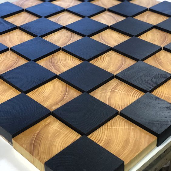 a wooden table with black squares on it