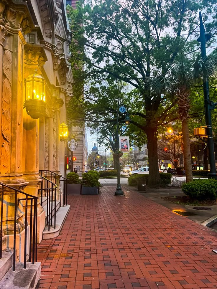 an empty brick sidewalk in the middle of a city