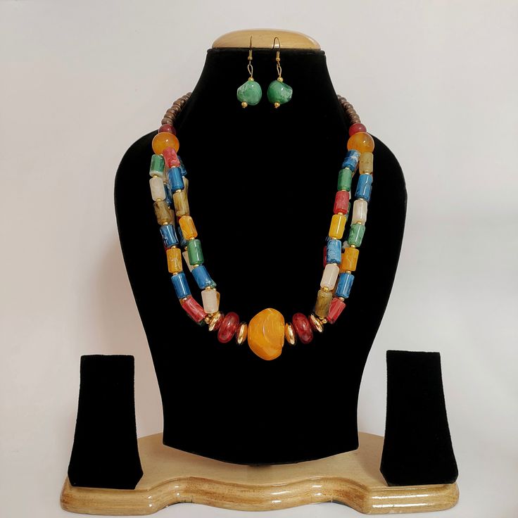 A stunning piece of Handmade Resin Indian Jewelry that embodies the spirit of Hippie and Tribal aesthetics. This unique necklace is a vibrant fusion of colors, culture, and craftsmanship, making it the perfect accessory to express your free-spirited and bohemian vibe. ❋❋ Shipping Methods ❋❋ Standard Delivery - Take up to 8-14 business days (Worldwide). ❋❋ Please be aware that the colors, shades, and texture shown may exhibit minor variations compared to the actual product due to limitations in d Handmade Multicolor Necklace For Festive Occasions, Multicolor Natural Stones Jewelry For Festival, Traditional Multicolor Natural Stones Necklaces, Traditional Multicolor Natural Stone Necklaces, Traditional Multicolor Natural Stones Necklace, Fusion Style Multicolor Necklace For Celebration, Spiritual Multicolor Beads For Gifts, Multicolor Round Beaded Jewelry For Festivals, Traditional Multicolor Beaded Necklace With Natural Stones