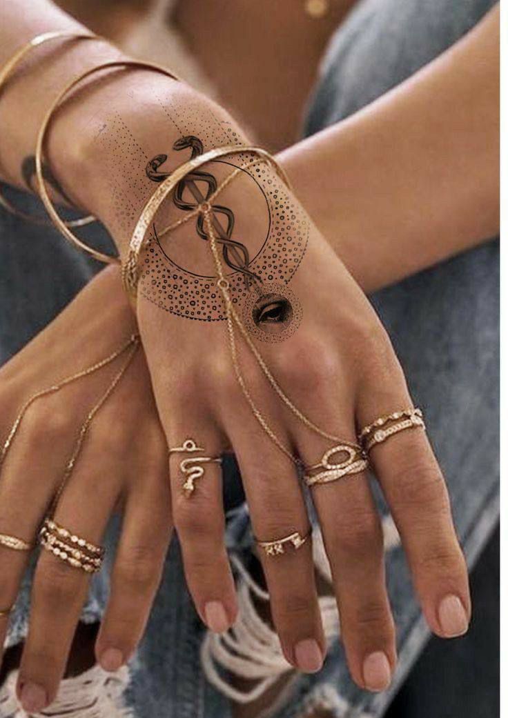 a woman's hands with rings and bracelets on them