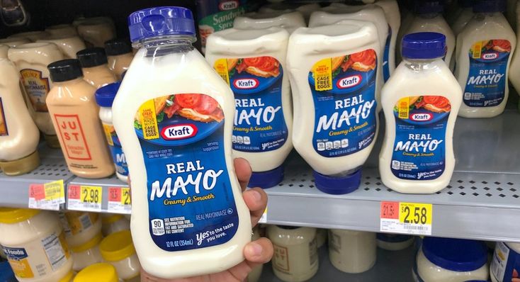 a person holding up a bottle of real mayo