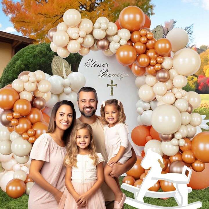 a family posing for a photo in front of a balloon arch