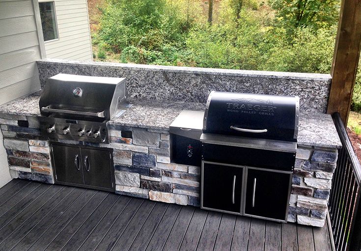 an outdoor bbq with grill and sink on the deck