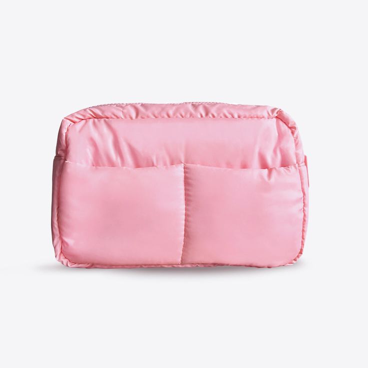 a small pink bag sitting on top of a white surface