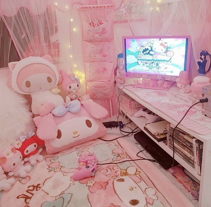 a room with pink walls and lots of stuffed animals on the floor in front of a tv